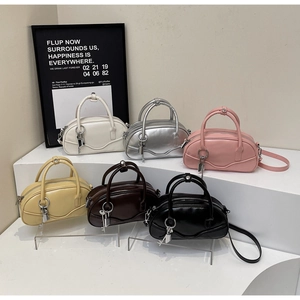 Detailed display of six colorful vintage bowling bags on a white tiered stand