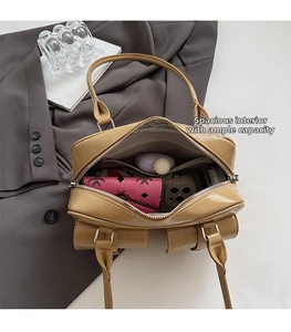 Spacious interior of caramel patent leather satchel filled with daily essentials