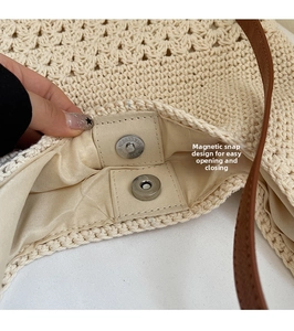 Detail of magnetic snap closure and woven texture on a large crochet beach shoulder bag