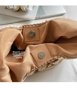 Detail shot of the large woven tote bag showing its magnetic snap button closure and lining