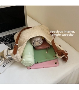 Detail view of large capacity beige crochet bag showing interior storage for tablets and umbrella