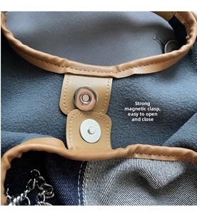 Detail of a gray woven bucket bag with brown leather trim and silver magnetic closure