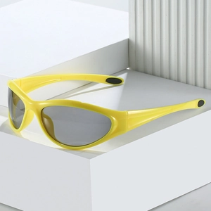 Close-up of bright yellow wraparound sports sunglasses with grey polarized lenses