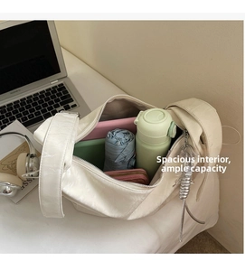 Interior view of spacious beige nylon bag showing capacity with tablet and umbrella