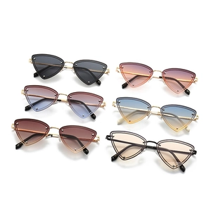 Detail view of triangular cat-eye metal sunglasses with micro-rivets in multiple gradient colors