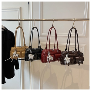 Detailed view of vintage Boston bags in four colors with star charms and front pockets