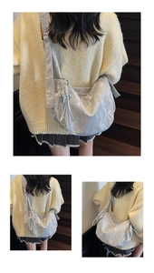 Detailed view of metallic silver shoulder bag with crinkled texture and wide strap