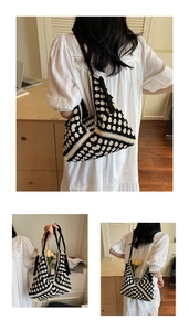 Detail view of a large woven tote bag with retro black and white knit floral patterns