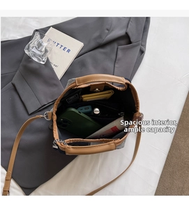 Spacious interior of canvas bucket bag holding a phone, power bank, and wallet