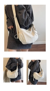 Detail of white nylon dumpling bag with silver heart charm and adjustable strap