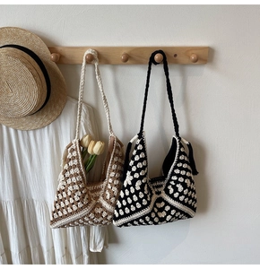 Detail view of handmade crochet shoulder bags with tassels and woven straps in bohemian style