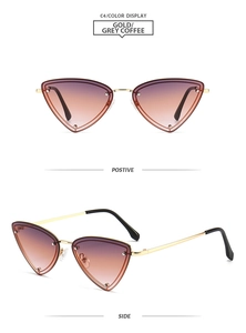 Detail view of gold metal triangle rimless sunglasses with gradient brown lenses
