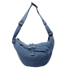 Minimalist blue denim crescent crossbody bag with adjustable wide strap and zipper closure