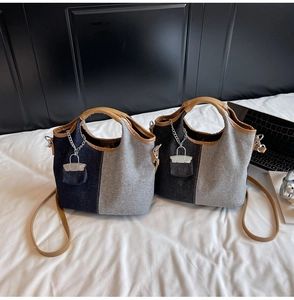 Detail of canvas bucket bags with denim patchwork, leather handles and chain pocket charm
