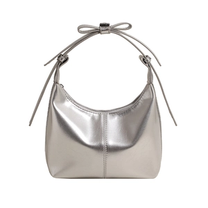 Silver metallic crescent bucket bag with bow detail and Y2K mirror finish fashion style