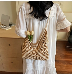 Detailed close-up of woven crochet tote bag featuring geometric diamond patterns and tassel