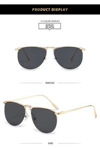Detail view of gold metal pilot sunglasses with double bridge and dark lenses