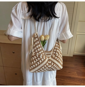 Detail of bohemian granny square crochet tote with tassels and woven texture