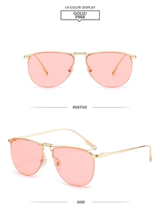 Detail view of gold metal pilot sunglasses with pink lenses and ergonomic nose pads