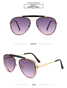 Detail view of gold aviator sunglasses featuring purple-pink gradient lenses and dual bridge