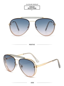 Detail view of gold metal pilot sunglasses featuring blue-pink gradient lenses