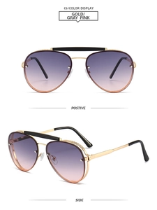 Close-up of gold metal pilot sunglasses with double bridge and pink gradient lenses