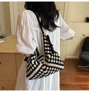 Close-up of woven tote bag featuring black and white checker pattern and tassel detail