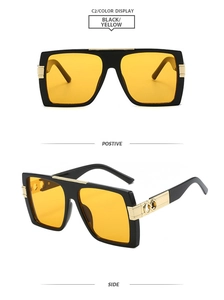 Detail of square oversized sunglasses with yellow lenses and golden temple hinge design