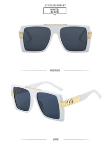 Close-up of square sunglasses with thick white frames and golden infinity metal hinges