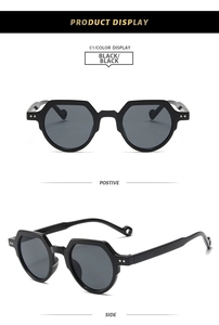 Detail view of black oval sunglasses with geometric frames and metal dot accents