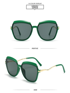 Close-up of green square sunglasses with polarized lenses and gold wavy metal temples