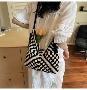 Detail of hand-woven black and white checkered crochet tote bag with tulip decoration