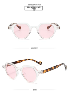 Detail view of oval pink lenses and tortoiseshell temples on retro fashion sunglasses