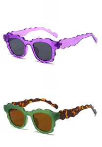 Detail view of wavy frame sunglasses in purple and green with 45-degree angle display