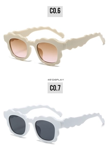 45-degree view of wavy frame sunglasses in cream and white with gradient lenses