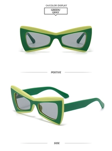 Detail view showing green geometric cat eye sunglasses with dual-tone frames and gray lenses