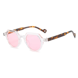 Retro oval sunglasses with transparent polygonal frames and pink lenses shown at 45-degree angle