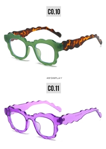 Detail view of wavy fashion sunglasses in green and transparent purple frames