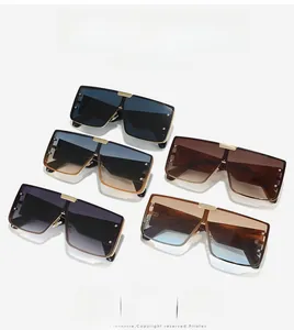 Flat lay of oversized square sunglasses in five trendy colors with gold metal bridges