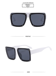 Detail of square oversized sunglasses with white frames and metal rivet accents
