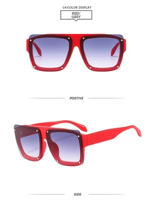 Detail view of red square oversized sunglasses featuring silver rivets and gradient lenses