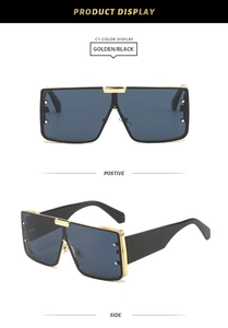 Close-up of golden metal frame square sunglasses with black wide temples and rivets