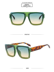 Detail view of square green sunglasses with tortoiseshell temples and gradient lenses
