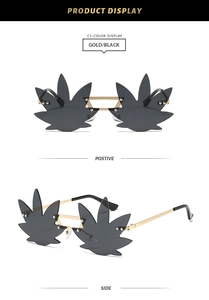 Detail of rimless leaf shaped sunglasses with gold metal frames and black lenses
