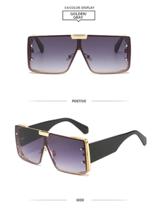 Macro detail of square gradient sunglasses with gold metal trim and wide black temples