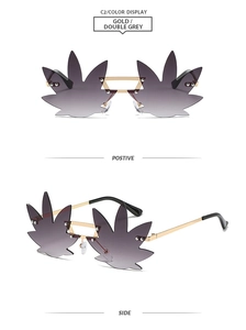 Detail of rimless gold metal sunglasses featuring creative maple leaf shaped grey lenses