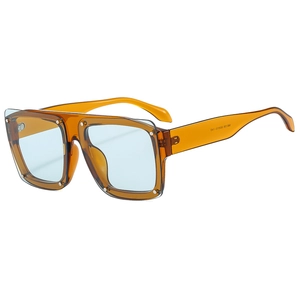 Fashionable oversized square amber sunglasses with light blue lenses and silver rivets