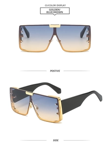 Detail of oversized golden metal square frame sunglasses with blue-brown gradient lenses