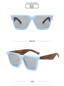 Detail view of square light blue matte sunglasses with gray lenses and tortoise temples