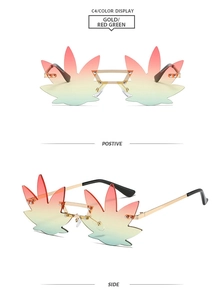 Detail view of rimless leaf-shaped sunglasses with red-green gradient lenses and gold frame